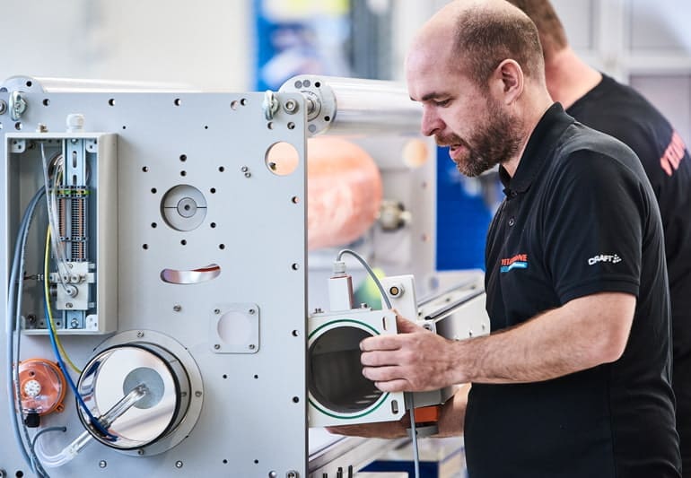 Vetaphone engineer installing extrusion system